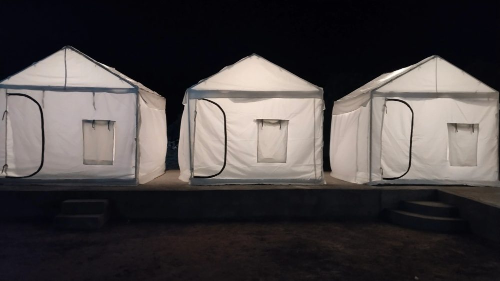 Row of camp tents at night