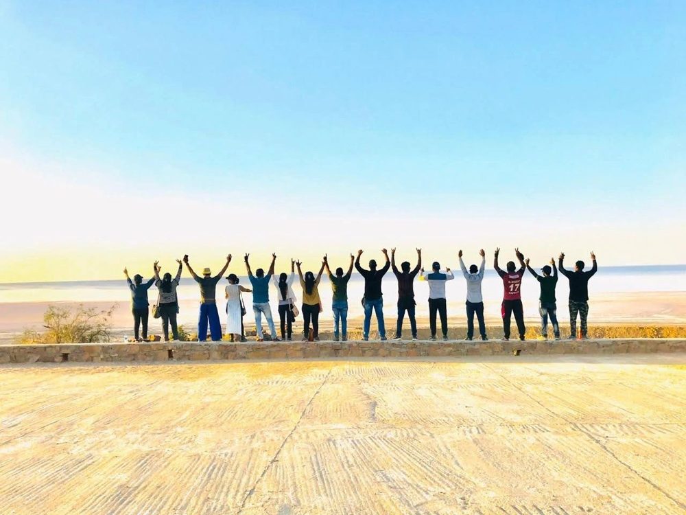 Travellers with arms raised on the Rann